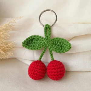 Handmade crochet cherry keychain in Pakistan with red cherries and green leaves