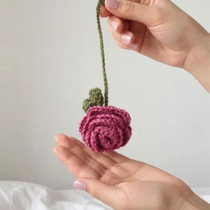 Handmade crochet rose keychain in pink with green hanging loop